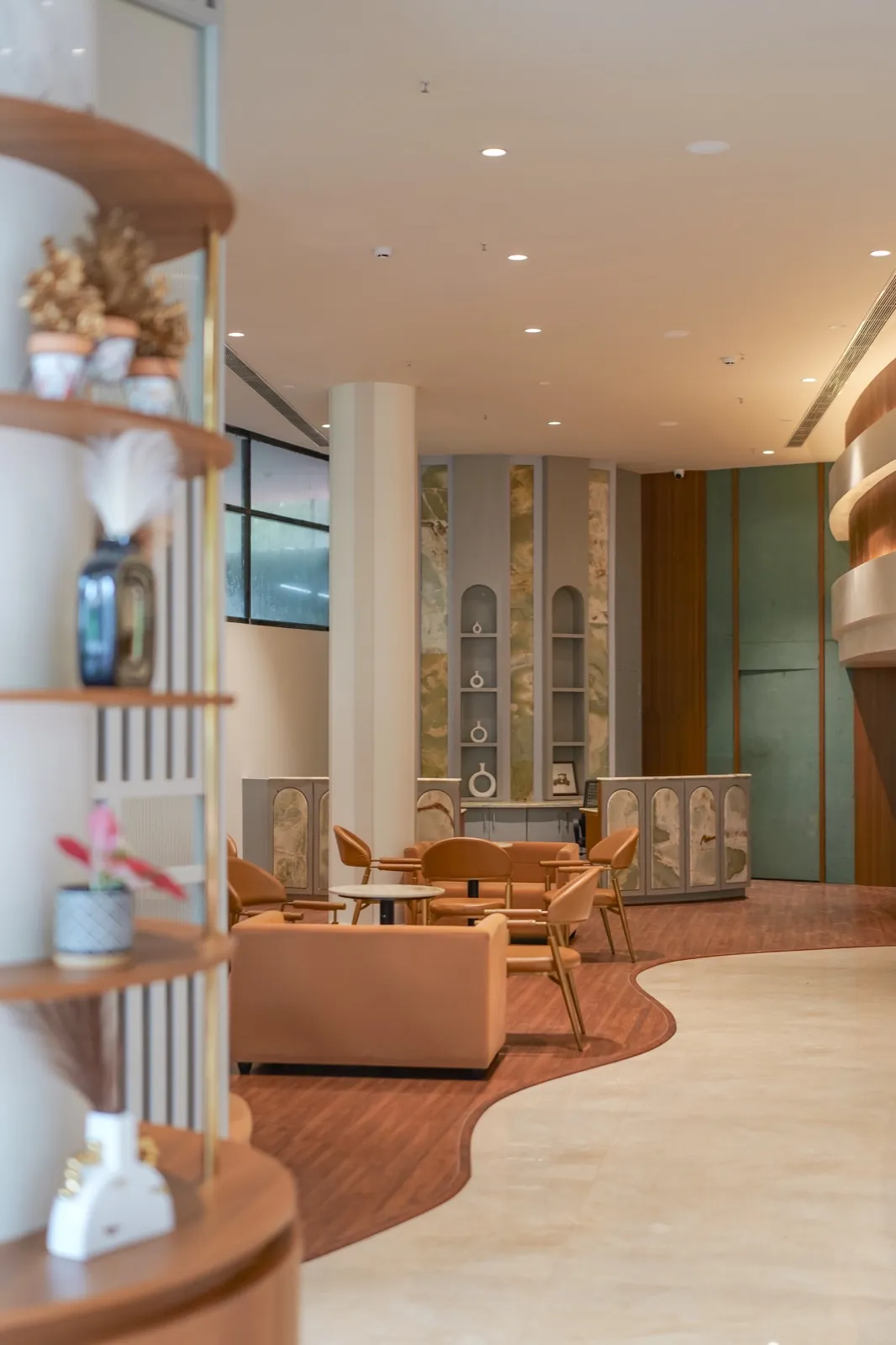 Hotel Explora Calicut lobby lounge with peach seating and marble reception